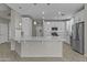 Gorgeous kitchen featuring a spacious island with breakfast bar, stainless appliances, and white cabinetry at 1162 E Ranch Ct, Gilbert, AZ 85296