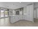 Open kitchen with white cabinets, stainless appliances, spacious island and backyard access at 1162 E Ranch Ct, Gilbert, AZ 85296