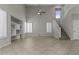 Open-concept living area with tile flooring, built-in shelving, and a ceiling fan creating a spacious atmosphere at 1162 E Ranch Ct, Gilbert, AZ 85296