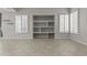 Bright living room with built-in shelving, tile floors, and shuttered windows, creating a warm inviting space at 1162 E Ranch Ct, Gilbert, AZ 85296
