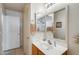 Clean bathroom with oak vanity, a large mirror, and neutral tile flooring at 12318 W Bloomfield Rd, El Mirage, AZ 85335