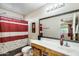Bright bathroom with large mirror, patterned shower curtain, and ample counter space at 12318 W Bloomfield Rd, El Mirage, AZ 85335