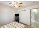 Cozy bedroom with ceiling fan, closet, and access to a bathroom at 12318 W Bloomfield Rd, El Mirage, AZ 85335