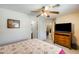 Comfortable bedroom featuring a ceiling fan, TV, and ensuite bathroom access at 12318 W Bloomfield Rd, El Mirage, AZ 85335