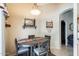 Inviting dining area featuring a rustic table setting and adjacent living spaces at 12318 W Bloomfield Rd, El Mirage, AZ 85335