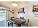 Quaint dining area featuring sliding glass door and backyard pool view at 12318 W Bloomfield Rd, El Mirage, AZ 85335