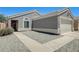 Single story home featuring a low maintenance front yard, sidewalk, and neutral paint color at 12318 W Bloomfield Rd, El Mirage, AZ 85335