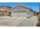 Single story home featuring a two car garage, low maintenance front yard, and neutral color scheme at 12318 W Bloomfield Rd, El Mirage, AZ 85335