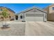 Single story home features a two car garage, low maintenance yard, and neutral color scheme at 12318 W Bloomfield Rd, El Mirage, AZ 85335