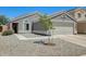 Single story home with a two car garage, low maintenance landscaping, and desert landscaping at 12318 W Bloomfield Rd, El Mirage, AZ 85335