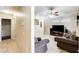 Hallway leading to the living room featuring tile floors and neutral walls at 12318 W Bloomfield Rd, El Mirage, AZ 85335