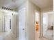 Well-lit hallway with multiple doors leading to different rooms in the home at 12318 W Bloomfield Rd, El Mirage, AZ 85335