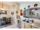 Well-lit kitchen area adjoins dining space, with wood cabinetry and stainless steel dishwasher at 12318 W Bloomfield Rd, El Mirage, AZ 85335