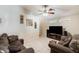 Comfortable living room boasts tile floors, a ceiling fan, and abundant seating for relaxation at 12318 W Bloomfield Rd, El Mirage, AZ 85335