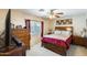 Cozy bedroom features a queen bed, wooden furniture, and a ceiling fan at 12318 W Bloomfield Rd, El Mirage, AZ 85335