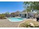 Backyard featuring a pool, covered patio, and low maintenance landscaping at 12318 W Bloomfield Rd, El Mirage, AZ 85335