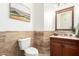 Stylish powder room with a vessel sink and decorative travertine tile at 1247 E Bautista Rd, Gilbert, AZ 85297
