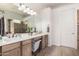 Bathroom featuring double vanity, soaking tub, glass shower, and modern fixtures at 1247 E Bautista Rd, Gilbert, AZ 85297
