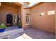 Welcoming front entrance features a decorative wrought iron door, potted plants, and a paved courtyard at 1247 E Bautista Rd, Gilbert, AZ 85297