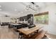 Open-concept kitchen and dining area features a large wooden dining table and modern light fixtures at 1247 E Bautista Rd, Gilbert, AZ 85297