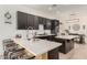 Modern kitchen with dark cabinetry, quartz countertops, a center island, and stainless steel appliances at 1247 E Bautista Rd, Gilbert, AZ 85297