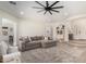 Bright living room features an open layout, a large sectional sofa, and a stylish ceiling fan at 1247 E Bautista Rd, Gilbert, AZ 85297