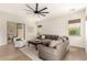 Cozy living room with large windows, comfortable seating, and wood-look floors at 1247 E Bautista Rd, Gilbert, AZ 85297