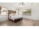 Well-lit main bedroom featuring a wood accent headboard and wood-look floors at 1247 E Bautista Rd, Gilbert, AZ 85297