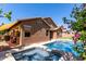 Backyard pool and spa with an attached home and flowering bushes at 1247 E Bautista Rd, Gilbert, AZ 85297