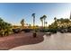 Expansive backyard with mature trees, flowers and a stone bench offering a serene outdoor experience at 13219 W Santa Ynez Dr, Sun City West, AZ 85375