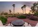 Backyard seating area with desert landscaping and fire table feature at 13219 W Santa Ynez Dr, Sun City West, AZ 85375