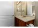 Bathroom vanity with granite countertops and mirrors, next to a door to the toilet and shower at 13219 W Santa Ynez Dr, Sun City West, AZ 85375