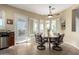 Inviting breakfast nook featuring a round table, chairs, and views through shuttered windows at 13219 W Santa Ynez Dr, Sun City West, AZ 85375