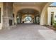 Covered entrance walkway with elegant arches, tile flooring, and a cozy fireplace at 13219 W Santa Ynez Dr, Sun City West, AZ 85375