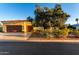 Single-story home with a tile roof, lush landscaping, and a three-car garage, basked in sunlight at 13219 W Santa Ynez Dr, Sun City West, AZ 85375