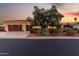 Inviting single-story home with a tile roof, lush landscaping, and a spacious three-car garage at 13219 W Santa Ynez Dr, Sun City West, AZ 85375