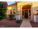 Inviting home entrance with a welcoming walkway and mature flowering landscape at 13219 W Santa Ynez Dr, Sun City West, AZ 85375