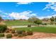 Scenic view of the golf course with golfers, golf carts, and beautiful landscaping at 13219 W Santa Ynez Dr, Sun City West, AZ 85375