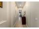 Inviting hallway with neutral tones, tiled floor, and decorative console table at 13219 W Santa Ynez Dr, Sun City West, AZ 85375