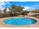 Inviting hot tub surrounded by a patio, lounge chairs, and mature landscaping at 13219 W Santa Ynez Dr, Sun City West, AZ 85375