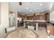 Bright kitchen boasts stainless steel appliances, center island with bar stools, and ample cabinet space at 13219 W Santa Ynez Dr, Sun City West, AZ 85375