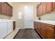 Functional laundry room with ample cabinet space and efficient washer and dryer setup at 13219 W Santa Ynez Dr, Sun City West, AZ 85375