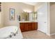 Luxurious bathroom with a soaking tub, vanity with a sink, and ample lighting at 13219 W Santa Ynez Dr, Sun City West, AZ 85375