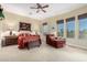 Serene main bedroom boasts plush carpet, large windows, and sitting area at 13219 W Santa Ynez Dr, Sun City West, AZ 85375