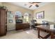 Inviting home office with custom wood desk, cabinetry and bright windows at 13219 W Santa Ynez Dr, Sun City West, AZ 85375