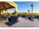 Charming covered patio with an outdoor grill, seating area, and serene views of the lush landscaping at 13219 W Santa Ynez Dr, Sun City West, AZ 85375