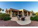 Inviting covered patio with ample seating and a fire pit, perfect for outdoor relaxation and entertaining at 13219 W Santa Ynez Dr, Sun City West, AZ 85375