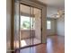 View from living room through glass doors of covered balcony with view of treed neighborhood at 1335 E June St # 221, Mesa, AZ 85203