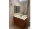 Well-lit bathroom featuring a large vanity mirror, a single sink, and ample cabinet storage space at 1335 E June St # 221, Mesa, AZ 85203