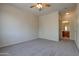 Bright bedroom with plush carpeting and ceiling fan, leading to a bathroom at 1335 E June St # 221, Mesa, AZ 85203
